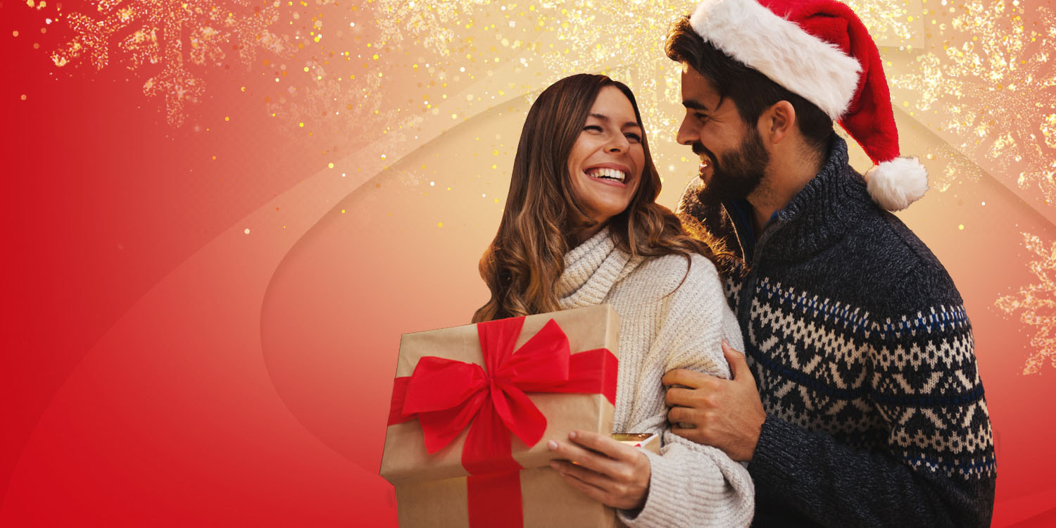 Young couple opening a gift certificate for Arthur Murray Dance Lessons